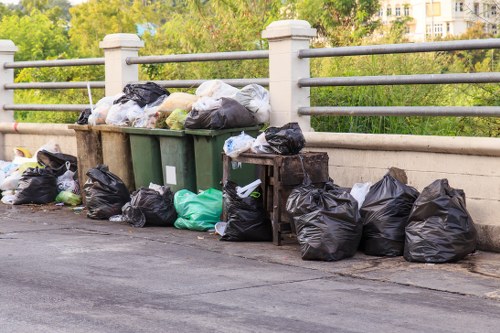 Commercial waste crew beginning cleanup in Peckham with safety gear